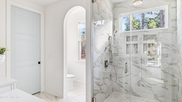 bathroom featuring walk in shower and toilet