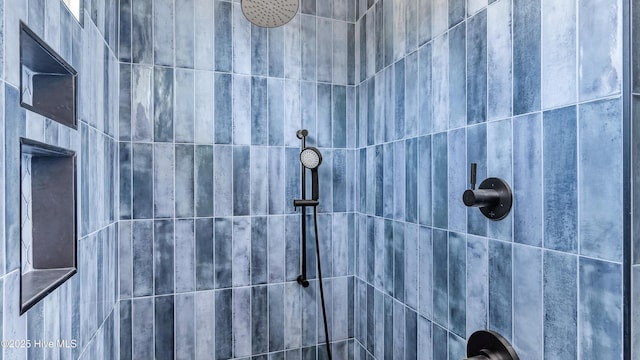 interior details featuring a tile shower