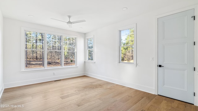 spare room with ceiling fan and light wood-type flooring