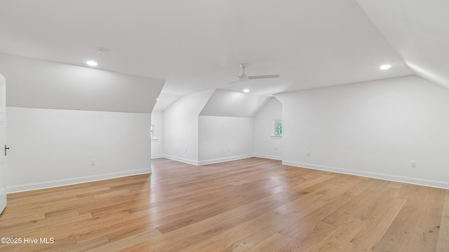 additional living space featuring lofted ceiling, light wood-type flooring, and ceiling fan