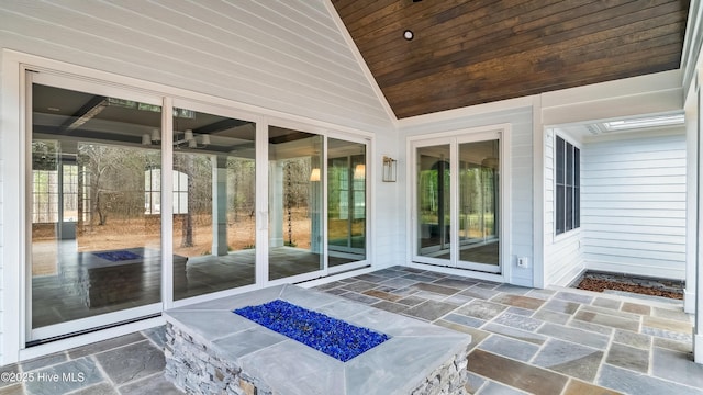 sunroom / solarium with lofted ceiling and wooden ceiling