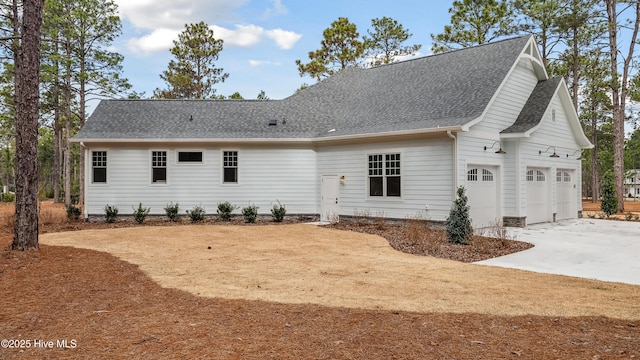 rear view of house featuring a garage