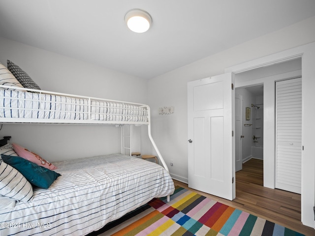 bedroom with dark hardwood / wood-style flooring