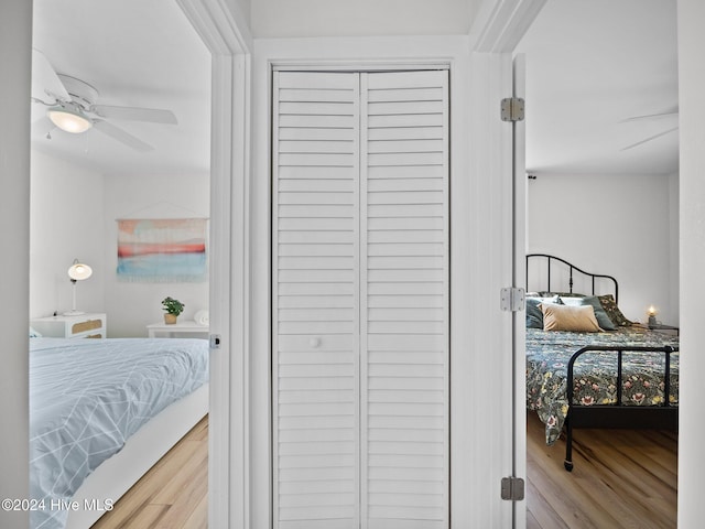 bedroom with ceiling fan, a closet, and hardwood / wood-style flooring