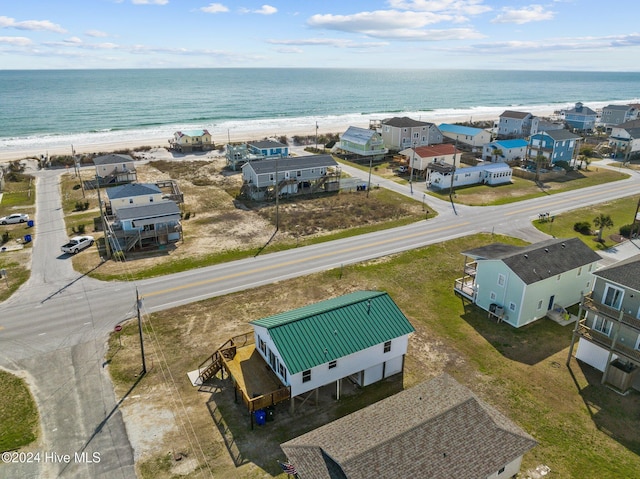 bird's eye view featuring a water view and a beach view