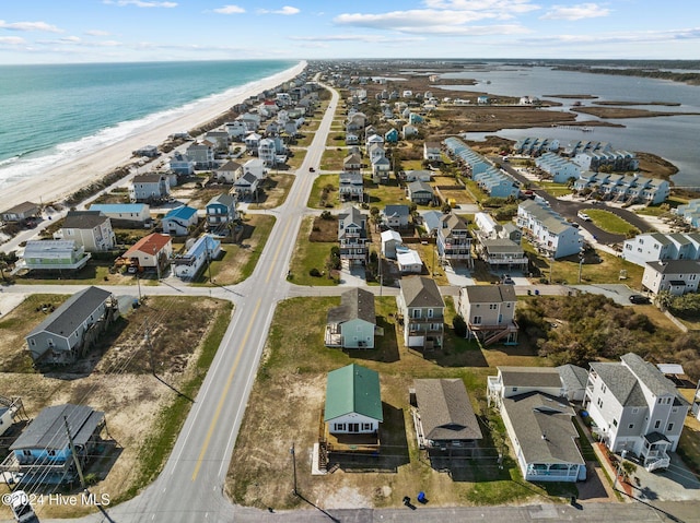 bird's eye view featuring a view of the beach and a water view