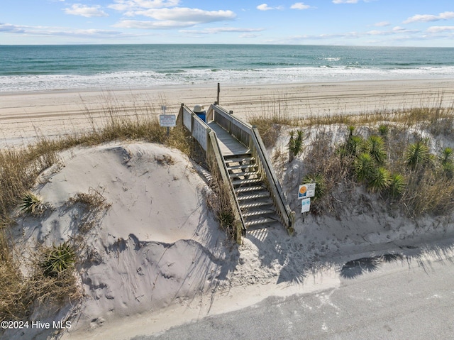 aerial view with a water view and a beach view