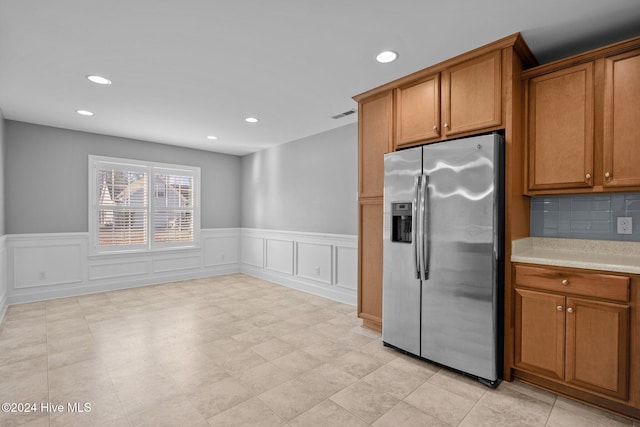 kitchen featuring stainless steel refrigerator with ice dispenser