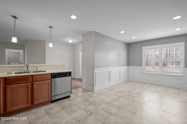 kitchen featuring stainless steel dishwasher, decorative light fixtures, and sink