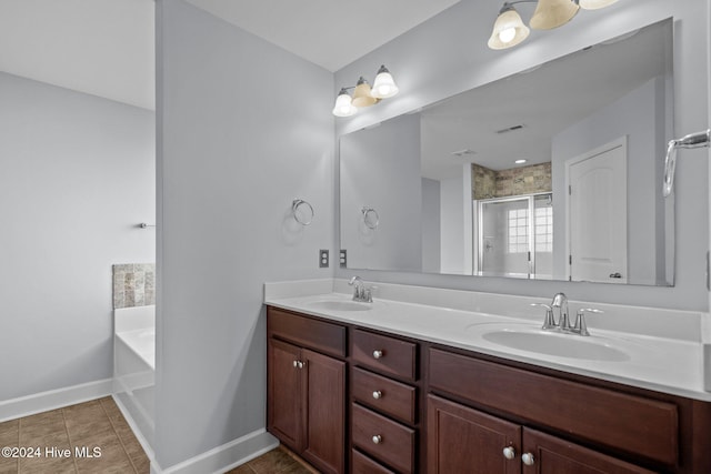 bathroom with shower with separate bathtub, vanity, and tile patterned floors