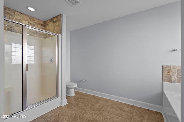 bathroom featuring shower with separate bathtub and toilet