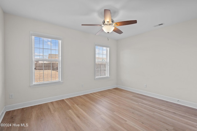 empty room with light hardwood / wood-style floors and ceiling fan