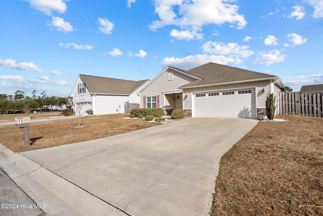 view of front of property with a front yard and a garage