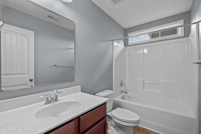 full bathroom with bathtub / shower combination, vanity, tile patterned flooring, and toilet