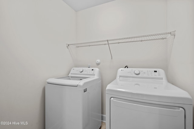 clothes washing area with washing machine and clothes dryer