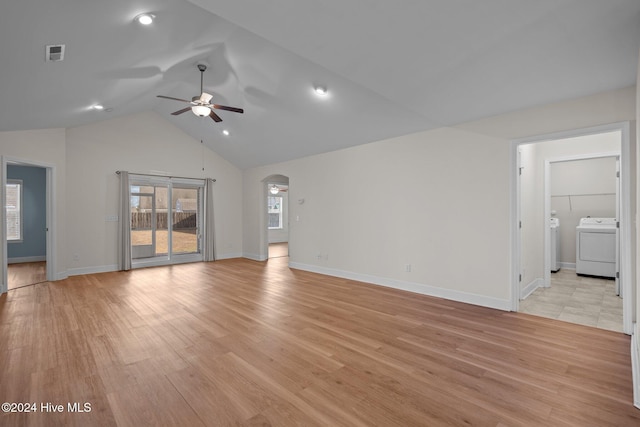 unfurnished living room featuring washing machine and dryer, ceiling fan, light hardwood / wood-style floors, and vaulted ceiling