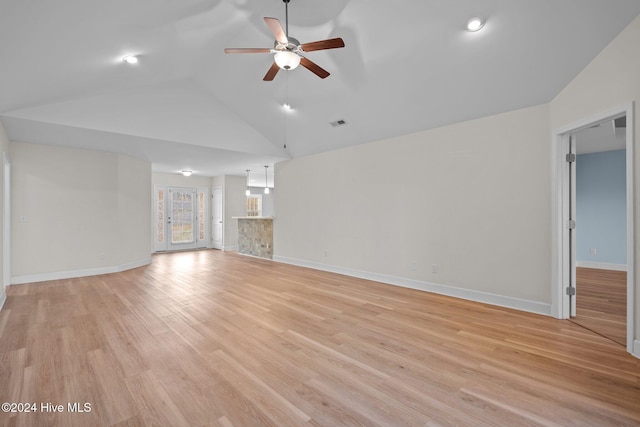 unfurnished living room with light hardwood / wood-style floors, ceiling fan, and lofted ceiling