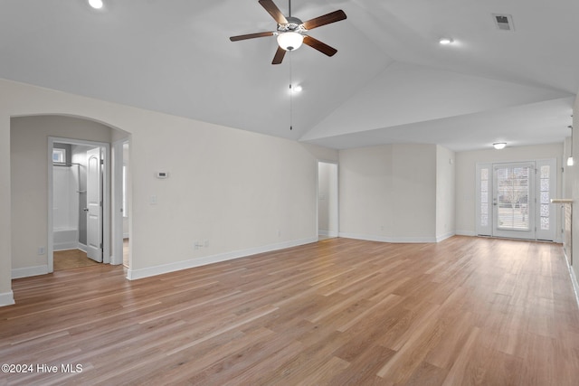 unfurnished living room with ceiling fan, lofted ceiling, and light wood-type flooring