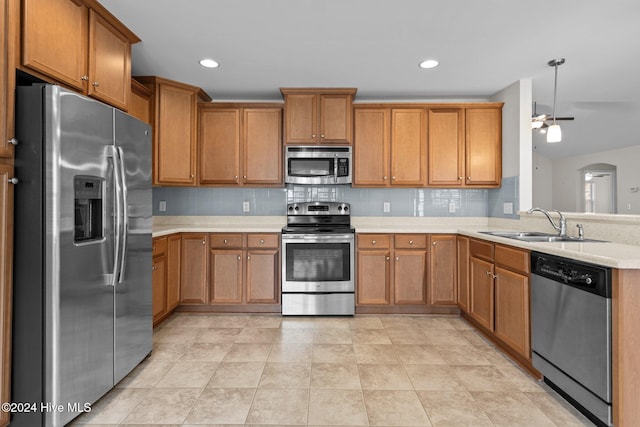 kitchen featuring appliances with stainless steel finishes, tasteful backsplash, ceiling fan, and sink