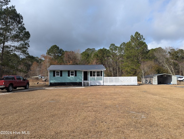 ranch-style house with a carport and covered porch