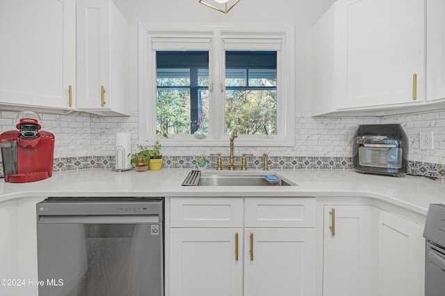 kitchen with white cabinets, backsplash, stainless steel dishwasher, and sink