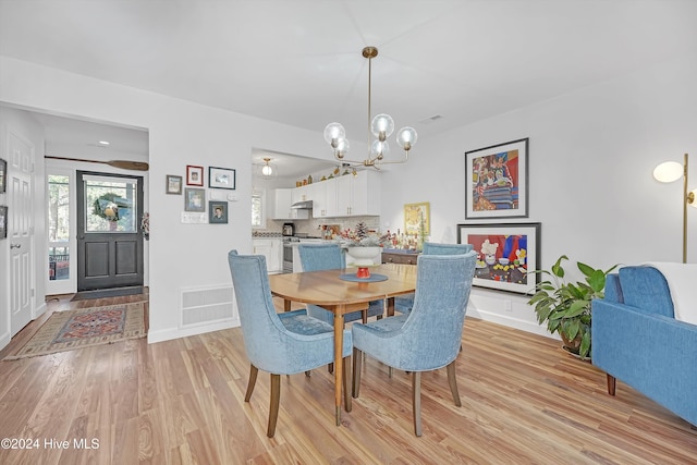 dining area featuring a chandelier and light hardwood / wood-style flooring