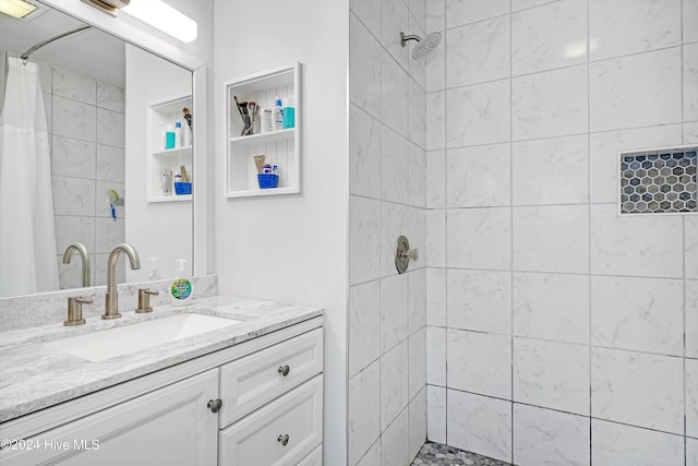 bathroom with curtained shower and vanity