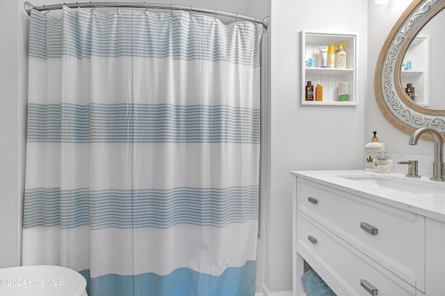 bathroom featuring curtained shower and vanity