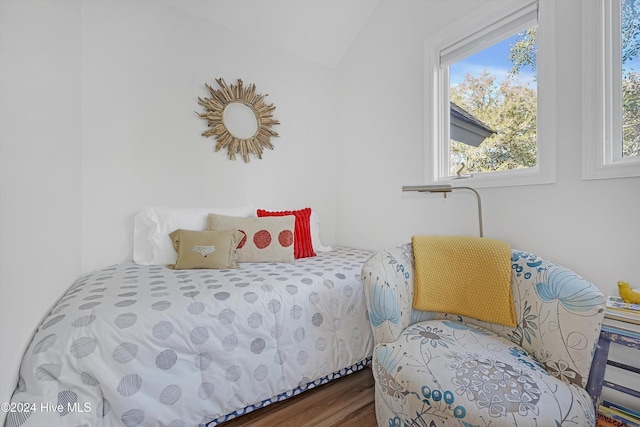 bedroom featuring lofted ceiling and hardwood / wood-style flooring