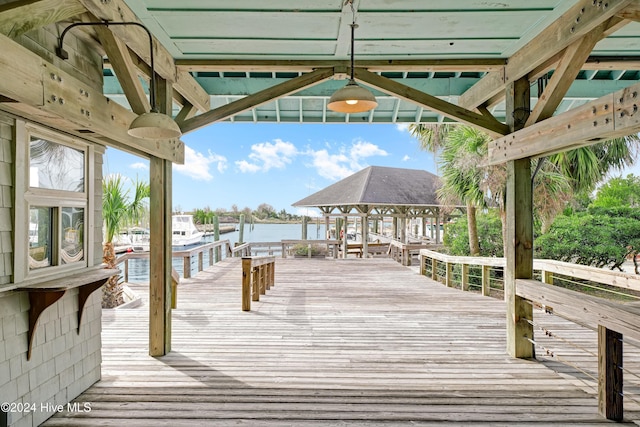 wooden deck featuring a dock and a water view