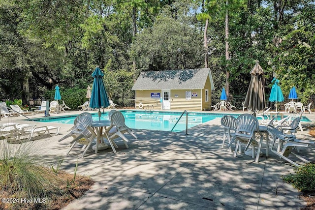 view of swimming pool with a patio area and an outdoor structure