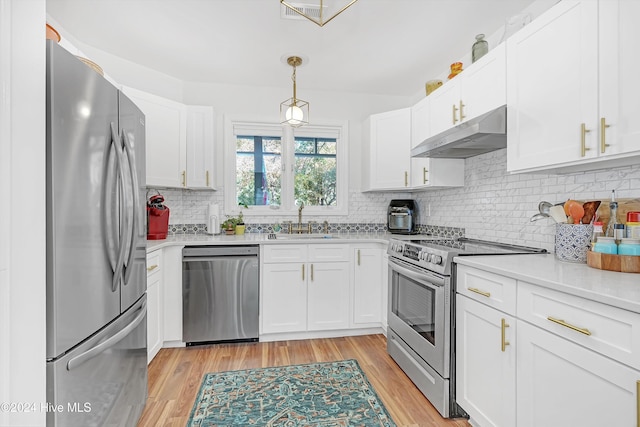 kitchen featuring light hardwood / wood-style flooring, white cabinets, and stainless steel appliances