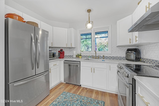 kitchen featuring white cabinets, sink, appliances with stainless steel finishes, and light hardwood / wood-style flooring