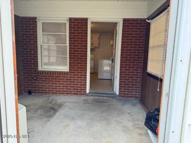 view of exterior entry with brick siding