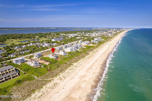 drone / aerial view featuring a water view and a view of the beach