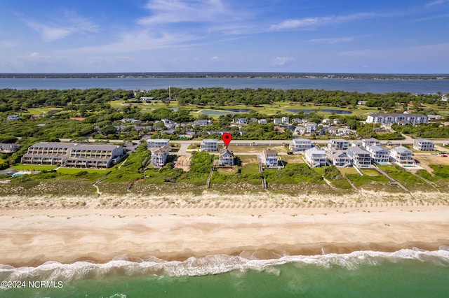 drone / aerial view featuring a beach view and a water view