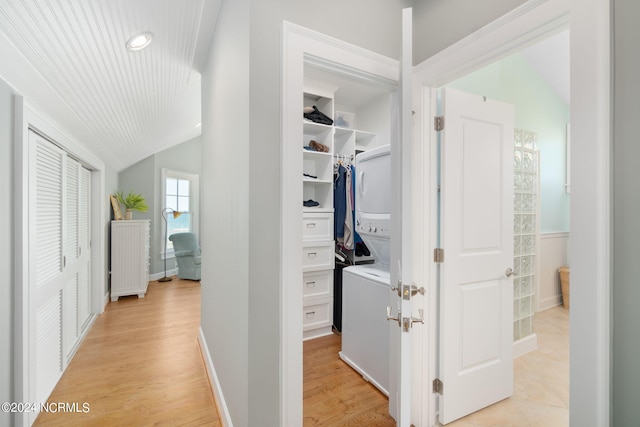 hall with lofted ceiling and light hardwood / wood-style floors