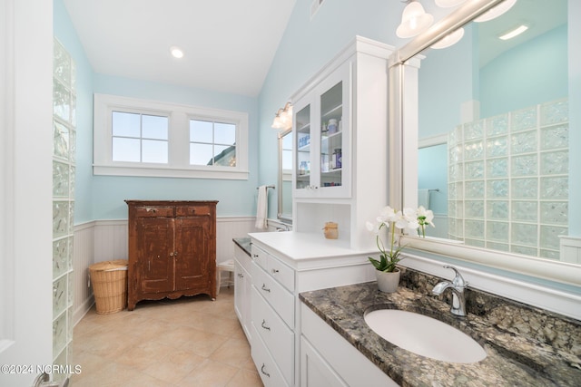 bathroom featuring vanity and lofted ceiling