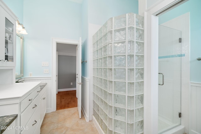 bathroom featuring vanity, an enclosed shower, and tile patterned flooring