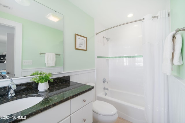 full bathroom with shower / bath combination with curtain, vanity, and toilet