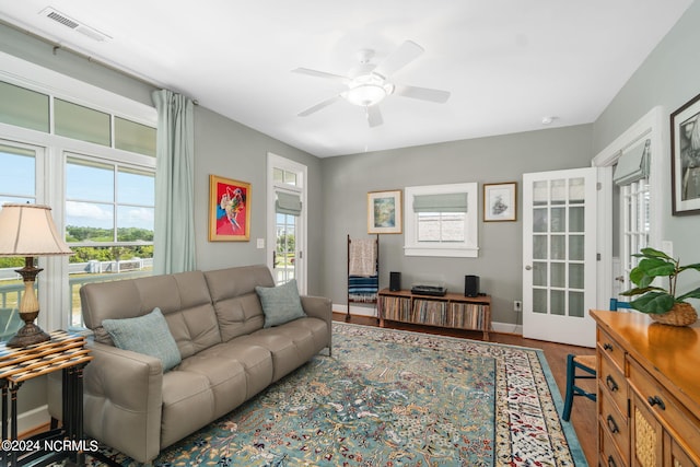 living room featuring ceiling fan and wood-type flooring