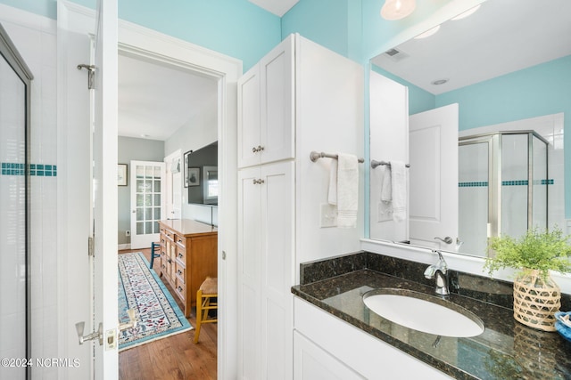 bathroom featuring vanity, hardwood / wood-style flooring, and walk in shower