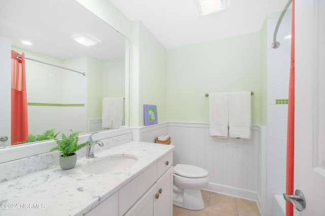 bathroom featuring vanity, tile patterned floors, and toilet