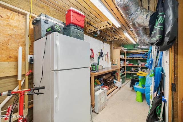 basement featuring white refrigerator