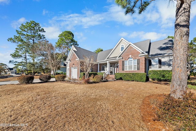 view of front facade featuring a front yard and a garage