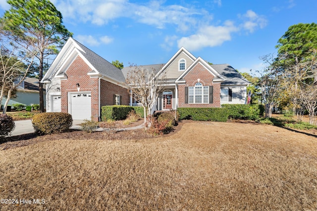 view of front of property with a front lawn and a garage