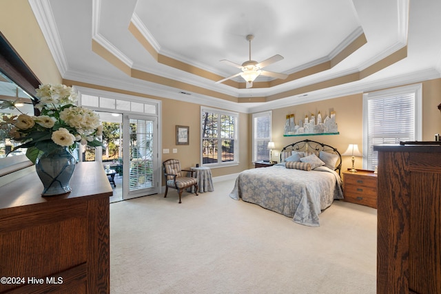 carpeted bedroom with french doors, a raised ceiling, ceiling fan, access to exterior, and ornamental molding