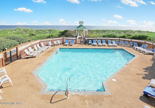 view of pool with a water view