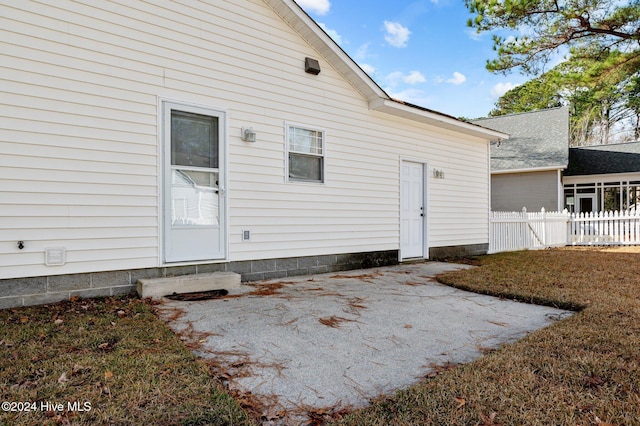 back of house featuring a lawn and a patio area