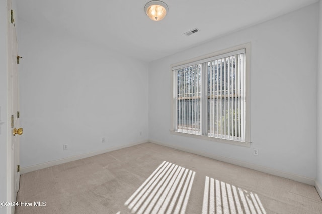 empty room featuring light carpet